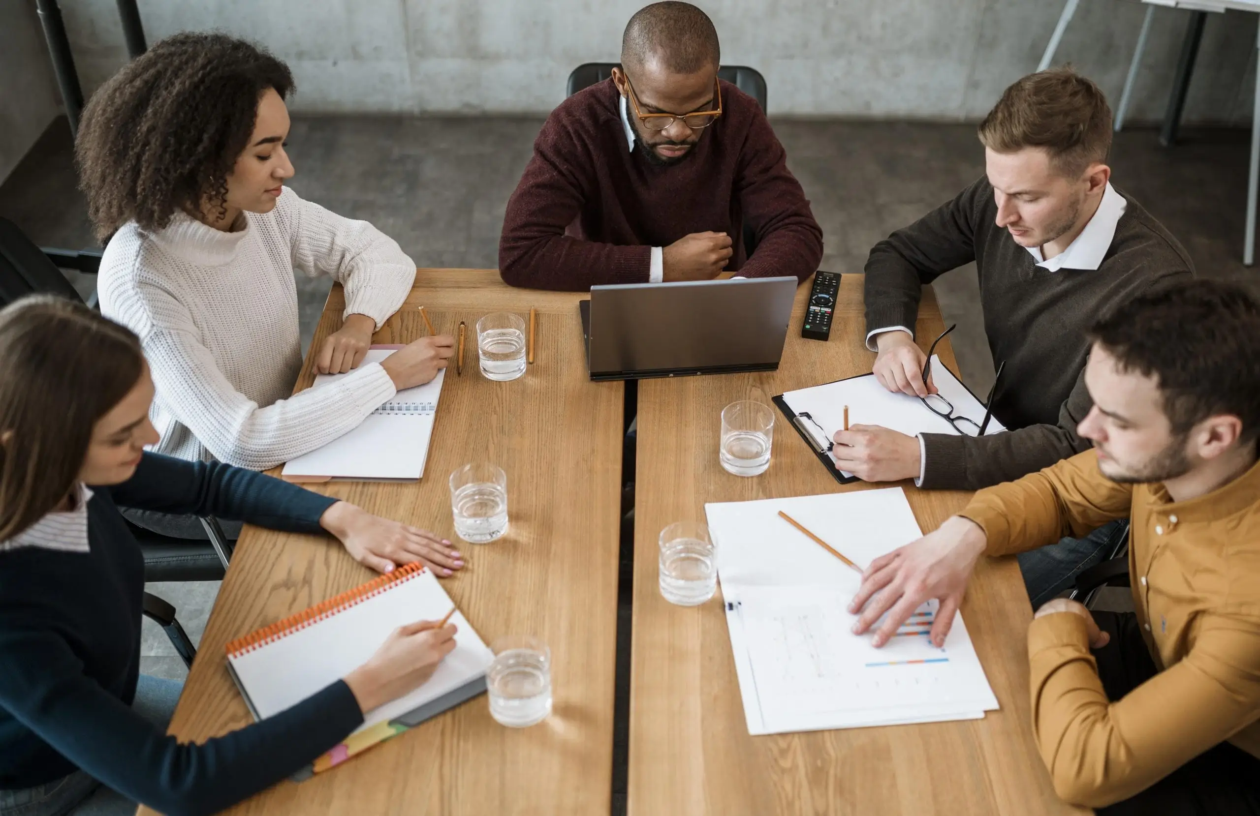 high-angle-people-table-office-meeting-scaled-1