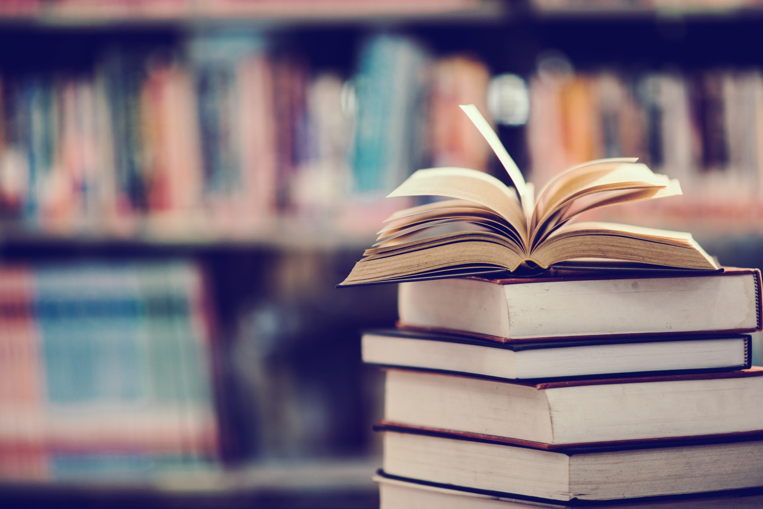 book-library-with-open-textbook-scaled